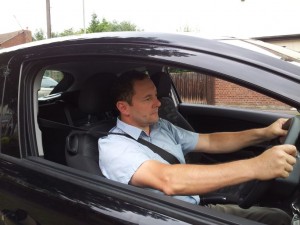 Lee driving his car